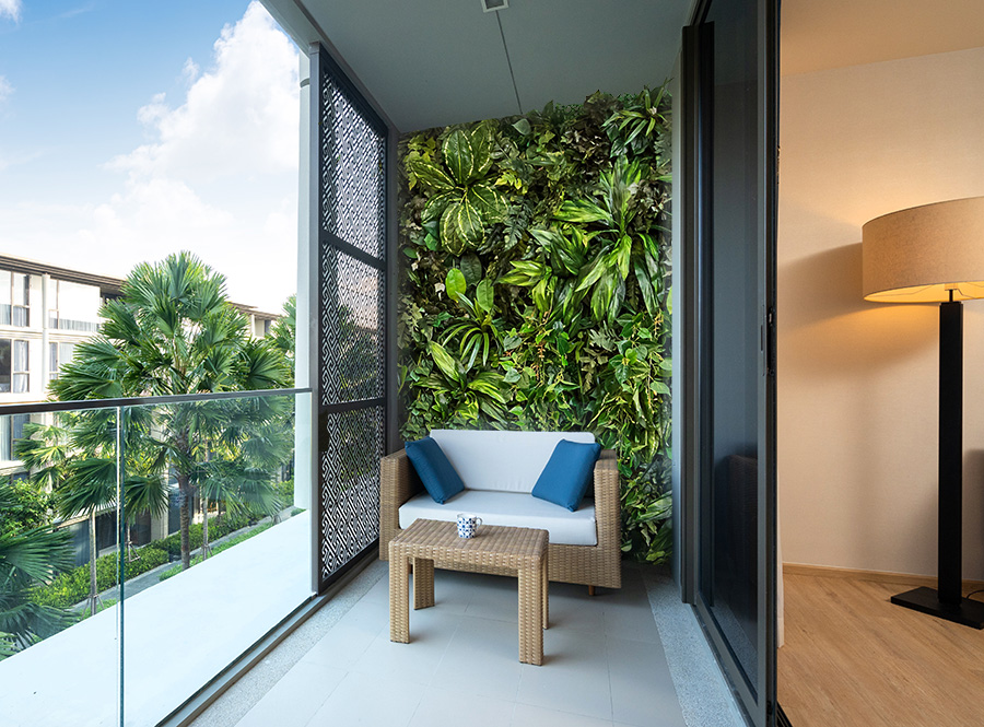 Zielona ściana ze sztucznych roślin na balkonie 
